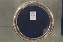 A circular silver photograph frame.
