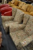A pair of wing armchairs upholstered in a liberty fabric.