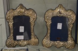 A pair of silver photograph frames.