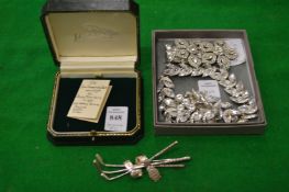 A silver golfing brooch and costume jewellery.