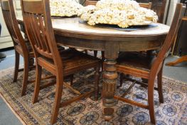 An oak extending dining table with one leaf.