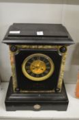 A large slate mantel clock.