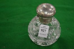 A cut glass and silver topped scent bottle.
