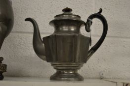 A pewter teapot.