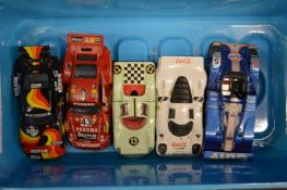 Five model Porsche racing cars.