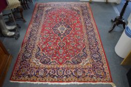 A Persian design rug, red ground with floral decoration 235cm x 145cm.