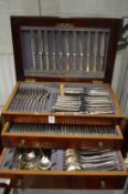 A mahogany canteen of cutlery.