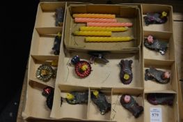 A collection of Christmas tree candle holders with candles.