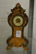 A miniature mantel clock.