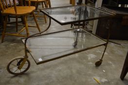 A brass and glass two tier trolley.