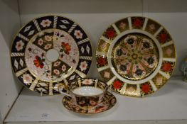 Royal Crown Derby Imari cup and saucer with two similar plates.