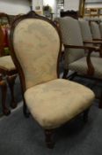 A Victorian upholstered bedroom chair.