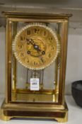 A good brass cased four glass mantel clock with mercury pendulum.