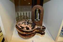Pottery bowls, a brass trivet and an icon.