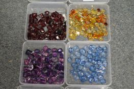 Four boxes containing coloured stones.