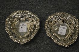 A pair of silver heart shaped bonbon dishes.
