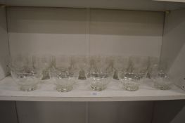 A shelf of engraved glassware.