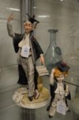 A Capodimonte figure of a teacher and pupil.