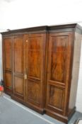A very good Georgian design mahogany breakfront four door wardrobe with fitted interior.