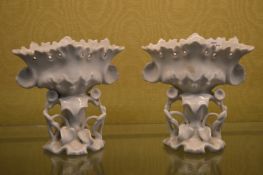 A pair of moulded white porcelain vases.