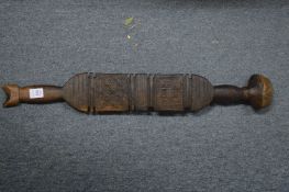 An Indonesian carved hardwood paddle or club.