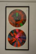 In the manner of Damien Hirst, a double spin picture, framed and glazed.