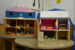 Two dolls houses with contents together with a suitcase containing dolls house furniture and