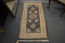 A Chinese rug 155cm x 80cm.