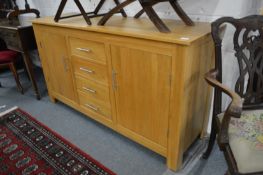 A modern light oak sideboard.