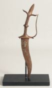 A SMALL INDIAN TULWAR DAGGER, with curving blade, together with stand, dagger 33cm long.