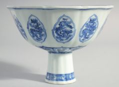 A CHINESE BLUE AND WHITE PORCELAIN PETAL FORM STEM CUP, decorated with dragon motifs, the interior