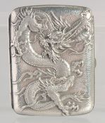 A JAPANESE MEIJI PERIOD REPOUSSE SILVER CIGARETTE CASE, decorated with a dragon, Junjin silver mark,