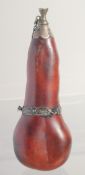 A SMALL POWDER FLASK, with metal mounts, possibly a type of nut, 16cm long.
