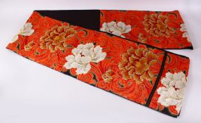 A FINE QUALITY JAPANESE EMBROIDERED SILK FUKURO OBI TIE, with a black and red ground with floral and