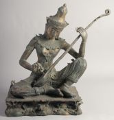 A LARGE 19TH CENTURY THAI RATTANAKOSIN DYNASTY BRONZE of Saraswati playing a vina, seated upon a