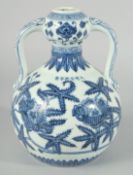 A CHINESE BLUE AND WHITE PORCELAIN TWIN HANDLE DOUBLE GOURD VASE, decorated with flower heads,