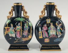 A PAIR OF ORIENTAL ENAMELLED VASES, with gilded handles and painted with figures, 22cm high.