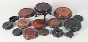 A COLLECTION OF FIFTEEN CHINESE CARVED HARDWOOD STANDS, largest 19.5cm overall, (15).