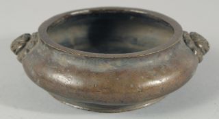 A CHINESE BRONZE TWIN HANDLE CENSER, with lion dog head handles and character mark to base, 15.5cm