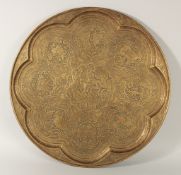 A LARGE ISLAMIC ENGRAVED BRASS TRAY, finely engraved with panels of figures on a foliate background,
