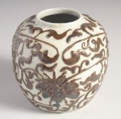 A CHINESE GLAZED POTTERY GINGER JAR, with relief floral decoration, 12cm high.