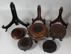A COLLECTION OF EIGHT CHINESE HARDWOOD STANDS, various types / sizes, largest 20cm diameter, (8).
