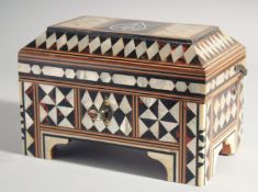 AN ISLAMIC MOTHER OF PEARL AND TORTOISESHELL INLAID WOODEN BOX, the hinged lid with calligraphic
