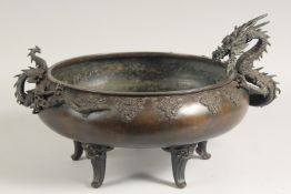 AN IMPRESSIVE 19TH CENTURY JAPANESE BRONZE CENSER, with applied bronze dragons as handles, relief
