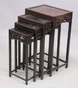 A GOOD LATE 19TH CENTURY NEST OF FOUR CHINESE ROSEWOOD RECTANGULAR TABLES, each with a pierced and