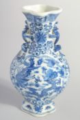 A CHINESE BLUE AND WHITE PORCELAIN VASE, with moulded handles and painted with dragon and phoenix,