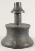 A VERY LARGE ISLAMIC ENGRAVED BRASS CANDLESTICK, with decorative roundels of floral motifs and