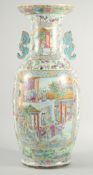 A VERY LARGE AND IMPRESSIVE CHINESE CANTON FAMILLE ROSE PORCELAIN VASE with moulded twin handles,