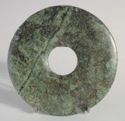 A SMALL HARDSTONE BI DISK, 12.5cm diameter.