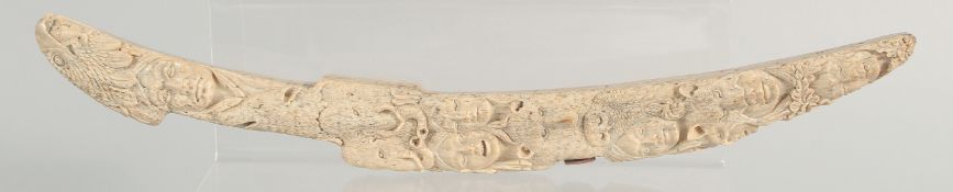 AN EXCEPTIONAL NORTH AMERICAN NATIVE INDIAN CARVED WALRUS TUSK, finely carved with multiple faces
